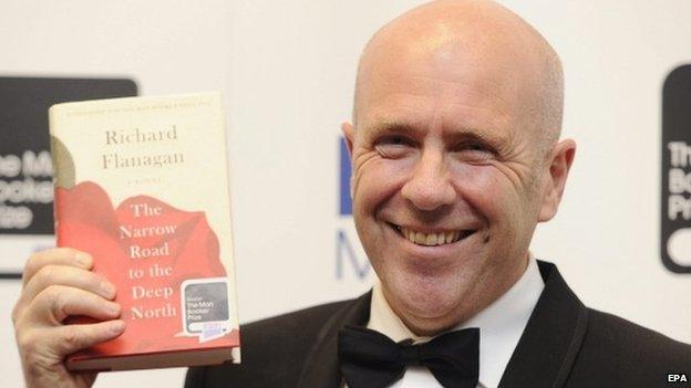 Australian novelist Richard Flanagan holds a copy of his book The Narrow Road to the Deep North