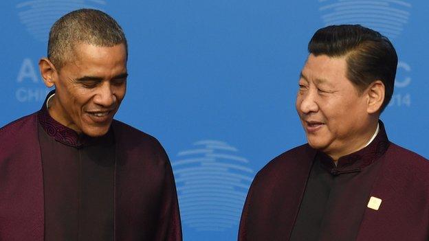 US President Barack Obama (L) stands with Chinese President Xi Jinping as they pose for a photo as he arrives for the Asia-Pacific Economic Cooperation