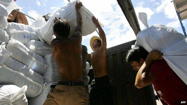 Labourers unload a shipment of slippers at Guanlei Port in Xishuangbanna Dai Autonomous Prefecture which borders Myanmar and Laos