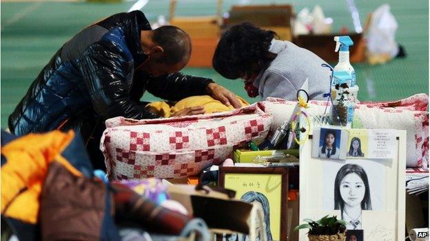 Relatives of the victims of the sunken ferry Sewol cry at a gym on South Korea's southwestern island of Jindo, where they have been staying at since the April 16 sinking of ferry Sewol, in Jindo, South Korea, Tuesday, 11 November 2014