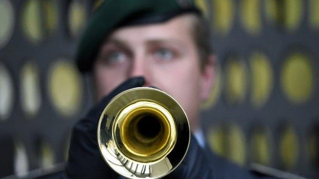 Soldier of the German armed forces plays the trumpet during a welcome ceremony