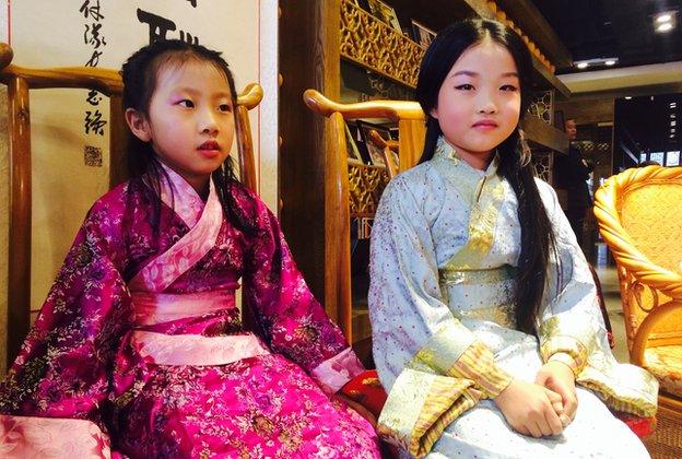 Screengrab of two girls at the Han Dress Association meeting