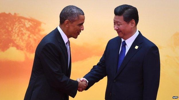 US President Barack Obama (L) shakes hands with China's President Xi Jinping as he arrives for the Asia-Pacific Economic Cooperation (APEC) leaders meeting at Yanqi Lake, north of Beijing on 11 November 2014.