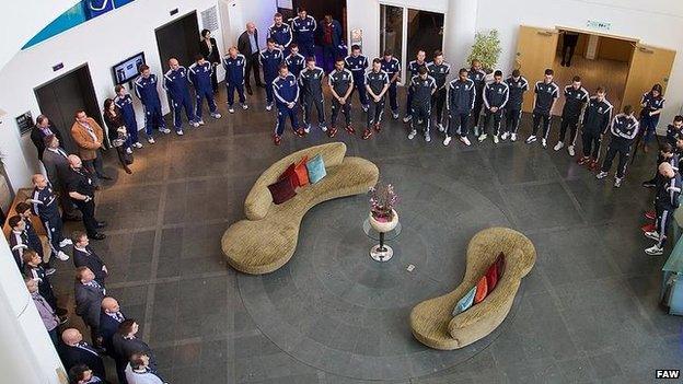 Wales players and staff during the two minute silence