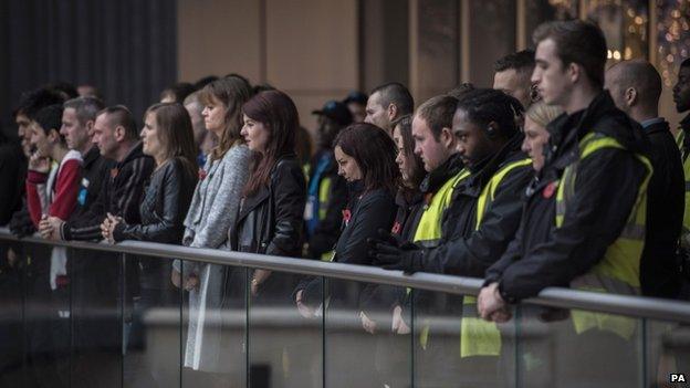 Staff and shoppers at a shopping centre in Bristol during the two minute silence.