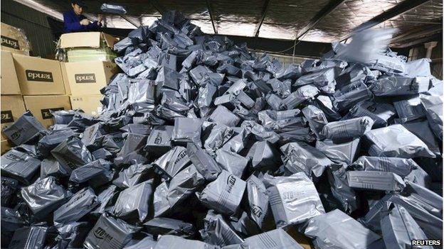 Employee sorting packages in Jiujiang, Jiangxi province, 11 November 2014