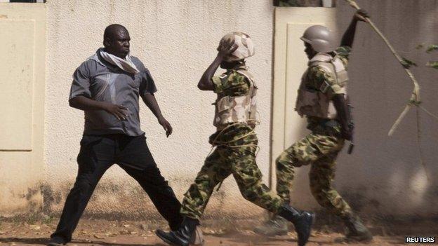 Lassina Sawadogo confronts soldiers in Ouagadougou, capital of Burkina Faso, on 30 October 2014