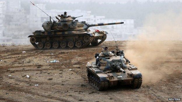 Turkish tanks manoeuvre near the Syrian border town of Kobane where Kurds are fighting Islamic State (11 Oct)