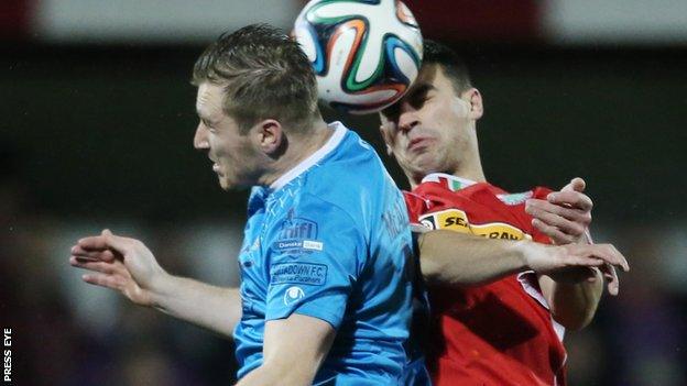 Portadown's Mark McAllister and Johnny Flynn of Cliftonville go up for a high ball