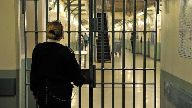 A prison officer locks a door at Wormwood Scrubs prison