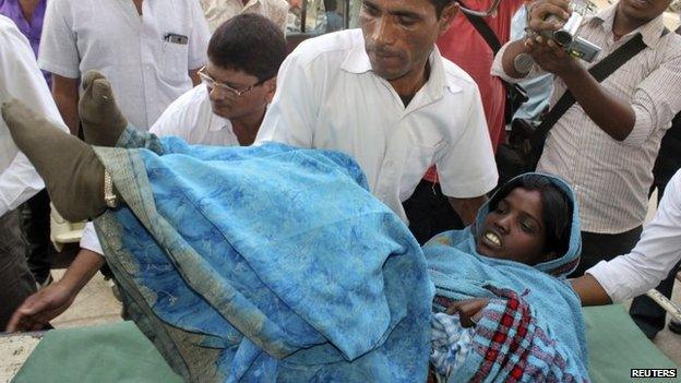 A woman who underwent sterilisation surgery at a government mass sterilisation camp is rushed to Chhattisgarh Institute of Medical Sciences (CIMS) hospital in Bilaspur, in the eastern Indian state of Chhattisgarh, 12 November 2014