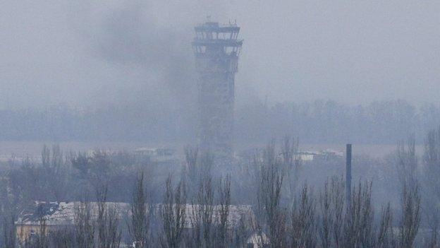 Smoke rises near the traffic control tower of the Sergey Prokofiev International Airport damaged by shelling during fighting between pro-Russian separatists and Ukrainian government forces, in Donetsk, eastern Ukraine, on 12 November 2014.