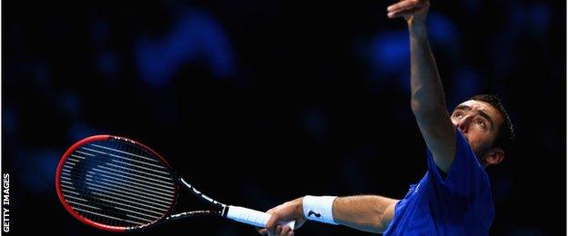 Marin Cilic serves against Tomas Berdych