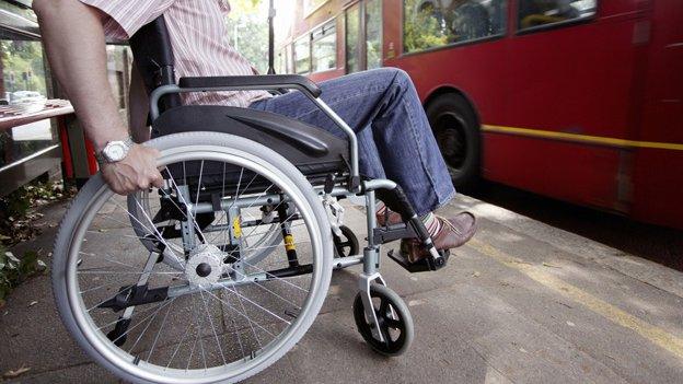 Man in wheelchair waiting for bus