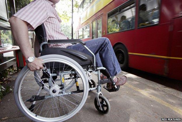 Man in wheelchair waiting for bus