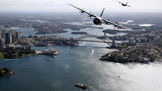 Two Royal Australian Air Force Hercules aircraft fly above the Sydney Opera House and Sydney Harbour Bridge during a display, in this handout picture released by the Australian Defence Force on 10 September, 2014