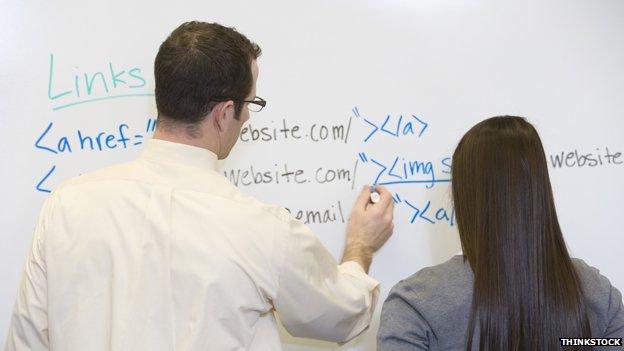 Teacher explains something to teenage girl pupil