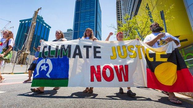 Demonstrators protest in the Brisbane CBD over climate change, uranium mining, coal seam gas fracking and traditional land rights ahead of the 2014 G20 Leaders Summit