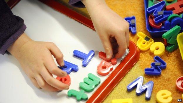 Child playing with letters