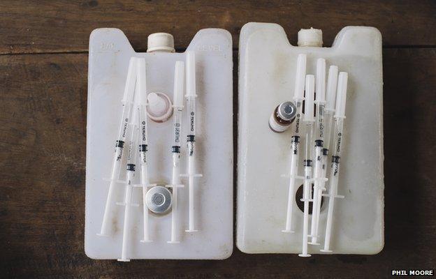 Polio (top left), live measles (top right) and yellow-fever (bottom left) vaccines sit on top of ice-packs