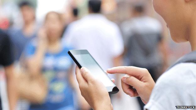 Woman on her mobile in a crowd