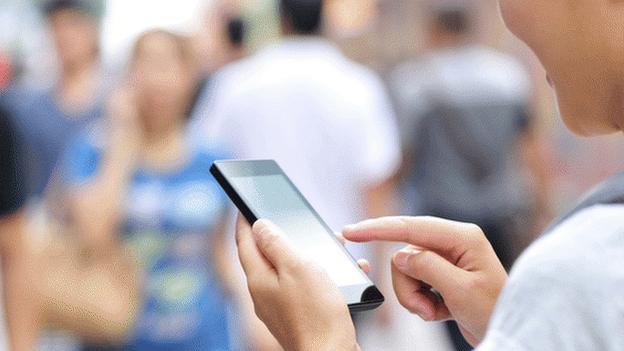 Woman on her mobile in a crowd