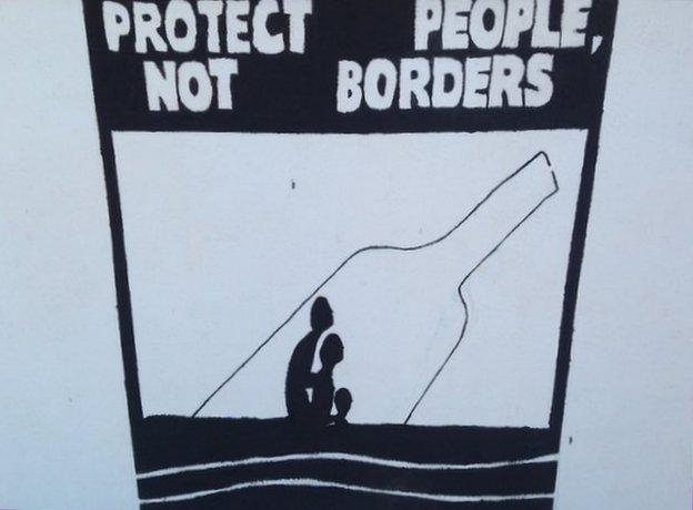 A painting "Protect people not borders" outside the mayor's office in Lampedusa