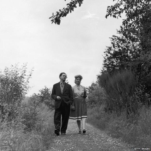 Dylan Marlais Thomas (1914 - 1953), Welsh poet, short-story writer and playwright, walking with his wife Caitlin, 10th August 1946.