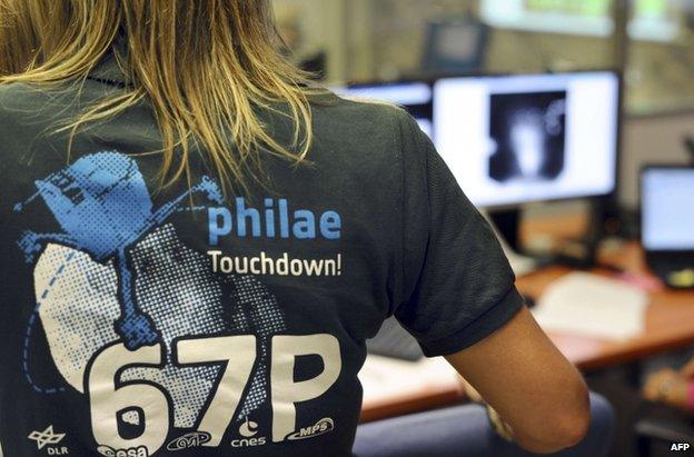 A scientists wears a t-shirt depicting the comet mission at the French space agency in Toulouse, 12 November