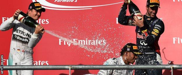 Lewis Hamilton of Britain (C) sprays champagne on the podium after winning the United States Formula One Grand Prix at the Circuit of The Americas in Austin, Texas on November 2, 2014.