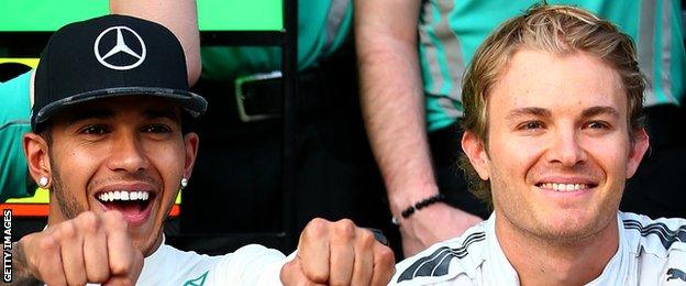 Hamilton of Great Britain and Mercedes GP celebrates his victory with Nico Rosberg of Germany and Mercedes GP and the team after the United States Formula One Grand Prix.