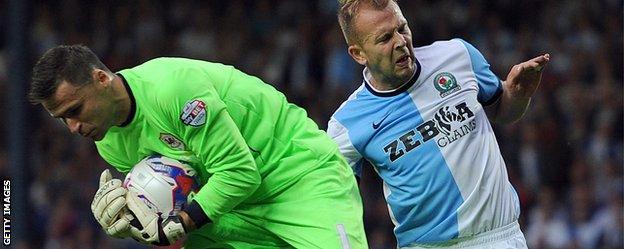 David Marshall saves while challenged by Blackburn's Scotland striker, Jordan Rhodes