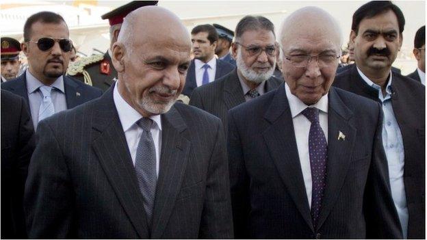Pakistan"s adviser on National Security and Foreign Affairs Sartaj Aziz, right, greets Afghan President Ashraf Ghani at Chaklala airbase in Rawalpindi, Pakistan, Friday, Nov. 14, 2014.