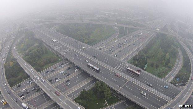 Vehicles drive on the Sihui overpass amid heavy haze and smog in Beijing, in this file picture taken on 11 October, 2014