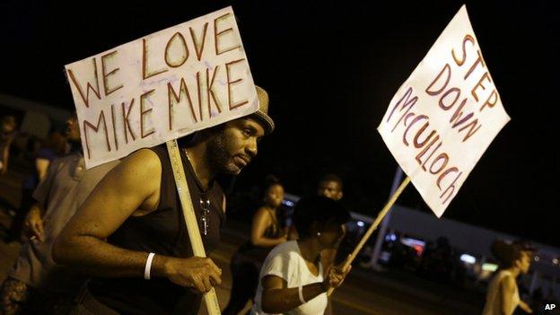 Protesters in Ferguson with signs calling for the removal of the prosecutor, Robert McCulloch, from the case.