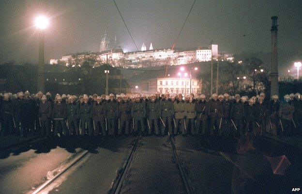 Riot police bar the bridge leading to the Castle of Hradcany