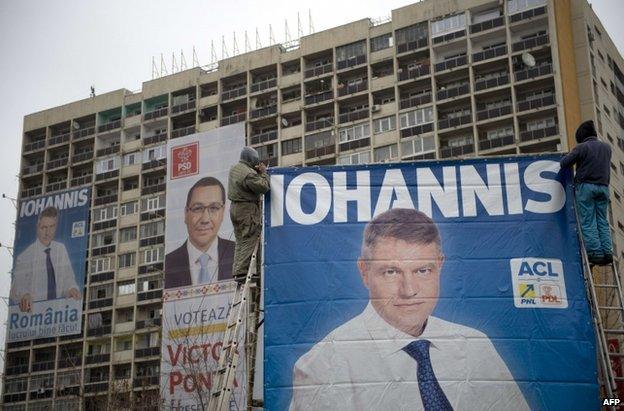 A poster of Victor Ponta between two of his rival Klaus Iohannis in Bucharest, 14 November