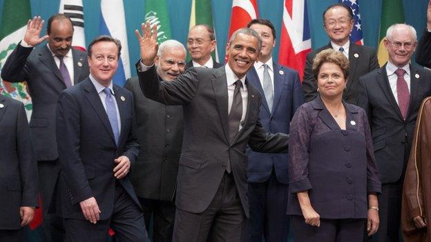 US President Barack Obama, centre, and Brazilian President Dilma Rousseff, right, walk off stage with other world leaders after the G20 Summit family photo in Brisbane, Australia, on 15 November 2014