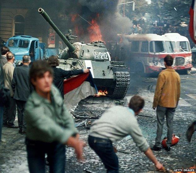 Prague residents throw burning torches to stop a Soviet tank in Prague August 1968