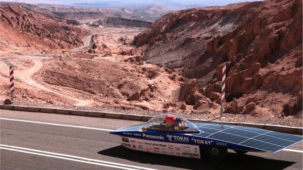 Solar-powered car in Chile desert with mountains in background, 14 November 2014