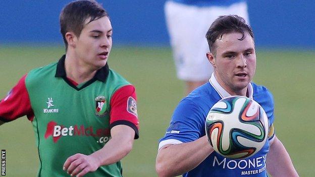 Jordan Stewart of Glentoran in action against Linfield's Jamie Mulgrew