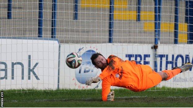 Dungannon keeper Andy Coleman saves Neil McCafferty's corner