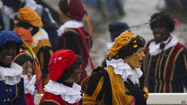 Traditional and a new style "Cheese Pete, right, take part in the parade for the arrival of Saint Nicholas in Gouda, Netherlands, Saturday, Nov 15