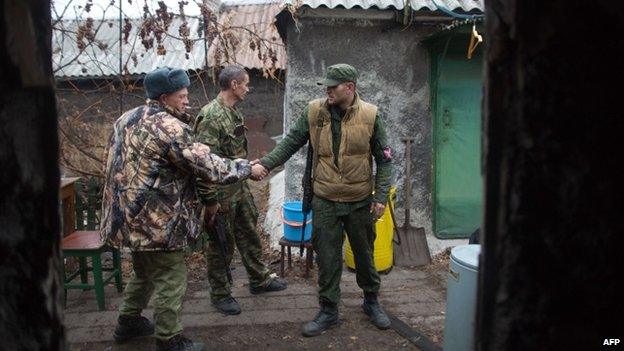 Pro-Russian gunmen greet each other in Donetsk on 13 November 2014