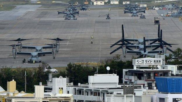 Multi-mission tilt-rotor Osprey aircraft sit at the US Marine's Camp Futenma in a crowded urban area of Ginowan, Okinawa prefecture, 14 November 2014