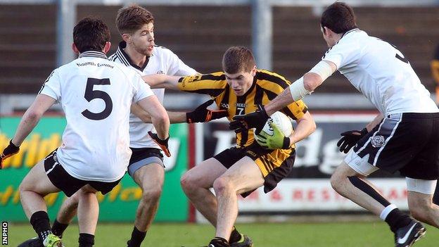 St Eunan's defender Darragh Mulgrew is challenged by Omagh trio Ciaran McLaughlin, Aaron Grugan and Justin McMahon