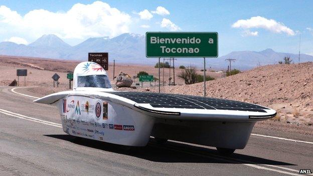 Solar-powered car in Chile desert with mountains in background, 14 November 2014