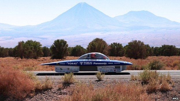 Solar-powered car in Chile desert with mountains in background, 14 November 2014