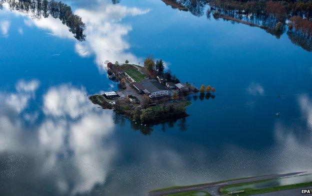 An aerial view of a flooded area near Lake Maggiore shows a farm surrounded by water near the village of Magadino in Ticino, Switzerland, on 16 November 2014