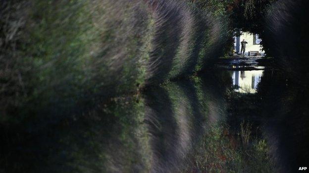 A man look down a flooded alley near Vigevano, nothern Italy, on 16 November 2014